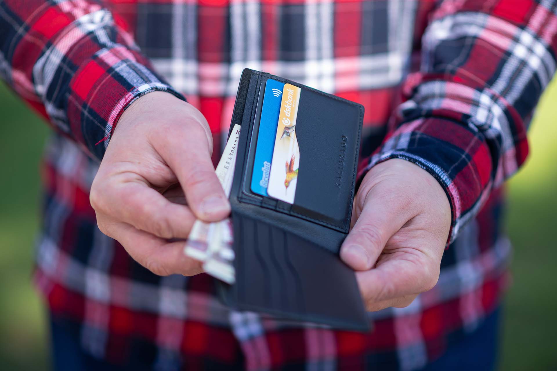 Man holding wallet open for late fees.